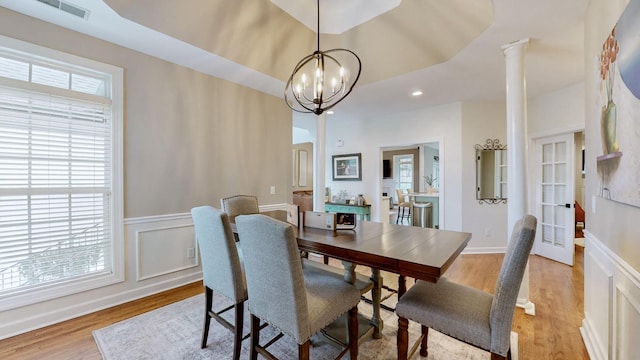 dining room with a notable chandelier, light wood finished floors, visible vents, and plenty of natural light