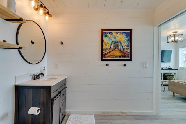 bathroom featuring wood ceiling, wooden walls, wood finished floors, and vanity