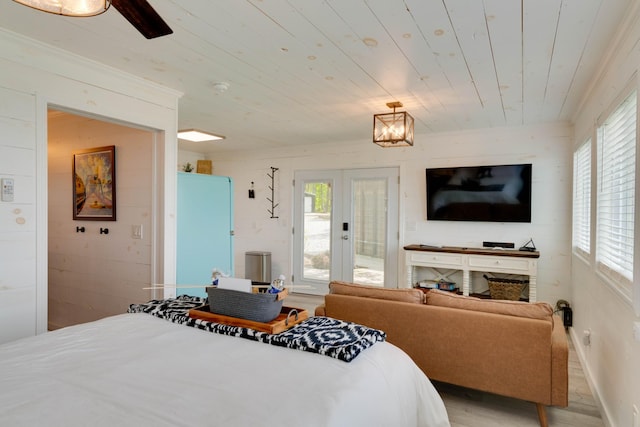 bedroom with wooden ceiling, multiple windows, wood finished floors, and access to exterior