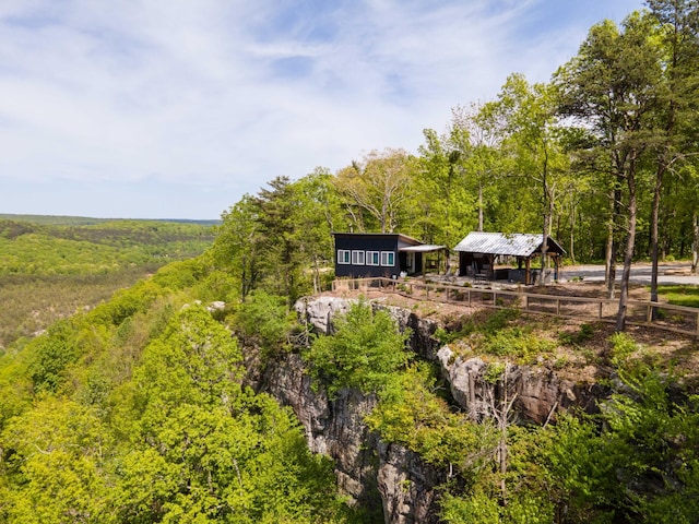 exterior space with a wooded view