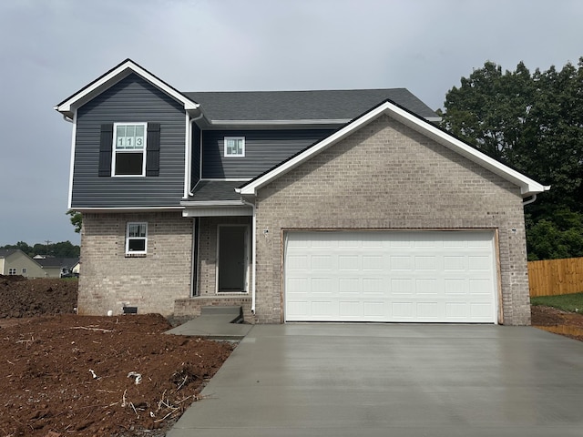 1229 Elizabeth Ln, Clarksville, TN 37042 - view of front of home with concrete driveway, brick siding, an attached garage, and a shingled roof