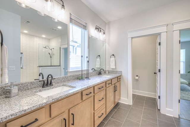 1084 Linn Cove Ct, Gallatin, TN 37066 - full bath featuring a tile shower, double vanity, visible vents, and a sink