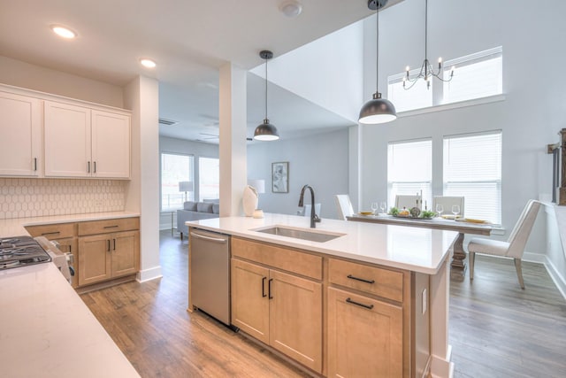 1084 Linn Cove Ct, Gallatin, TN 37066 - kitchen with light countertops, dishwasher, a sink, decorative backsplash, and light wood-style flooring