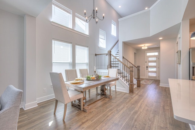 1084 Linn Cove Ct, Gallatin, TN 37066 - dining room featuring stairway, a high ceiling, an inviting chandelier, wood finished floors, and baseboards