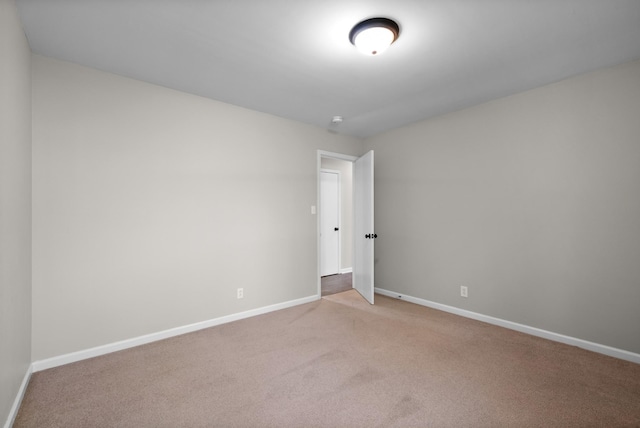 carpeted spare room with baseboards