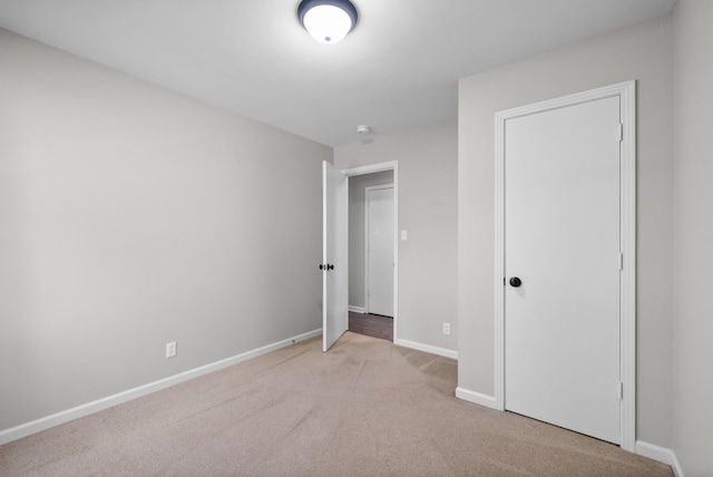 unfurnished bedroom featuring baseboards and carpet