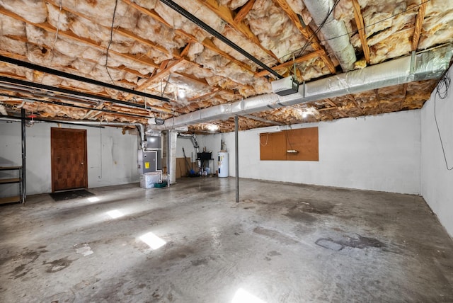 below grade area with water heater, heating unit, and a garage