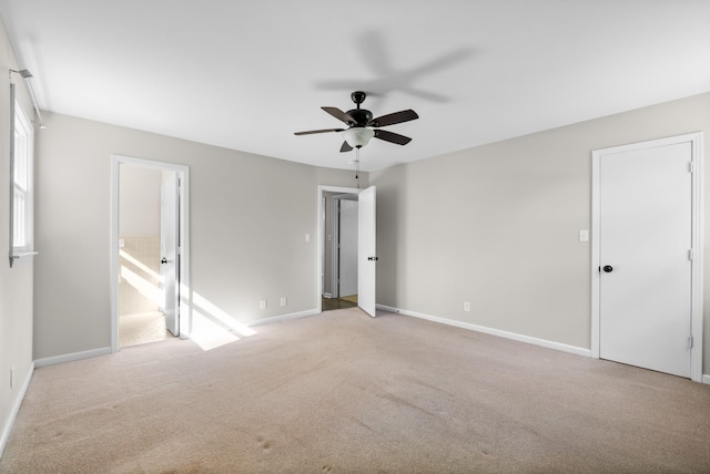 unfurnished bedroom with baseboards, carpet, and connected bathroom