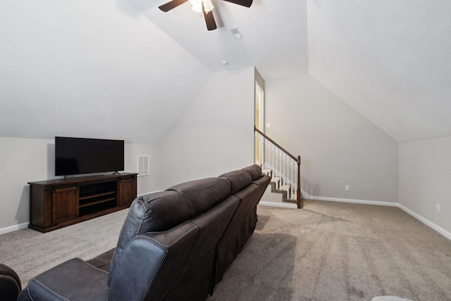 carpeted living area with lofted ceiling, a ceiling fan, baseboards, and stairway