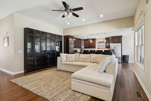 living room featuring dark wood-style floors, visible vents, baseboards, recessed lighting, and ceiling fan
