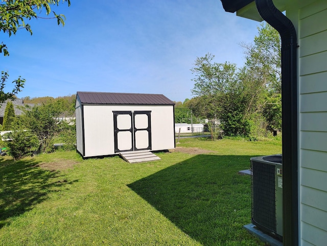view of yard with a storage unit, cooling unit, and an outdoor structure
