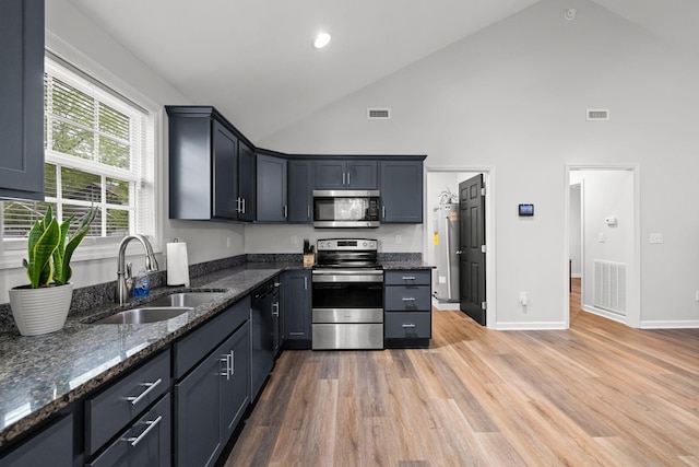 kitchen featuring visible vents, stainless steel appliances, and a sink