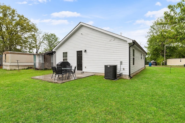 back of property featuring central air condition unit, a yard, and a patio area