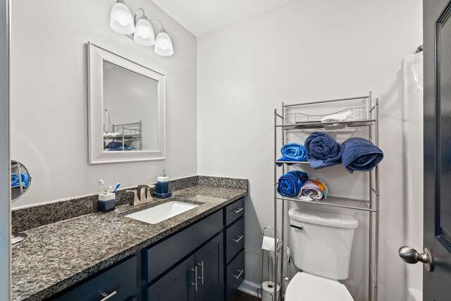 bathroom with toilet and vanity