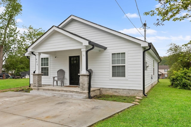 bungalow-style home with a porch and a front lawn