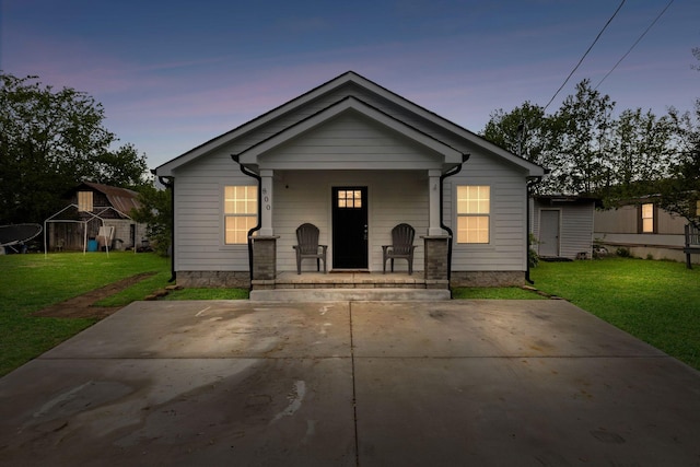 bungalow-style home featuring a porch and a front lawn