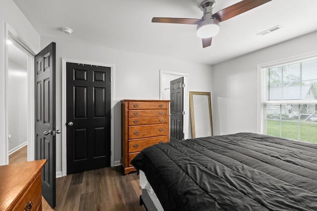 bedroom with visible vents, ceiling fan, and dark wood-style flooring