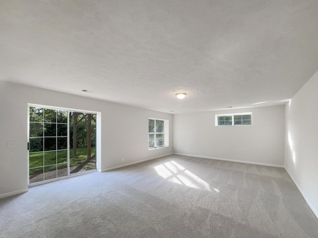 spare room with visible vents, baseboards, and carpet