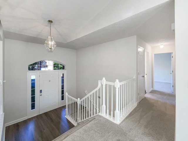 foyer entrance featuring vaulted ceiling and wood finished floors