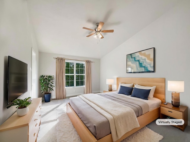 carpeted bedroom featuring lofted ceiling and ceiling fan