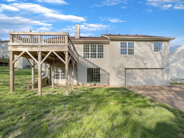 back of property featuring a chimney, aphalt driveway, a yard, a wooden deck, and a garage