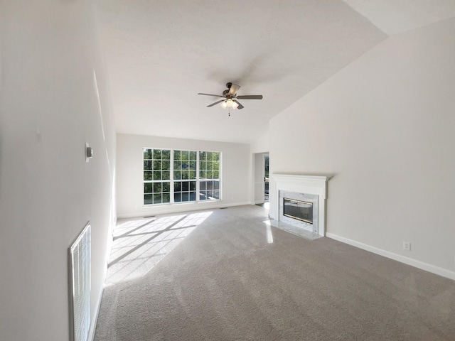 unfurnished living room with carpet, ceiling fan, baseboards, lofted ceiling, and visible vents