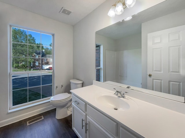 full bath featuring wood finished floors, visible vents, toilet, and vanity