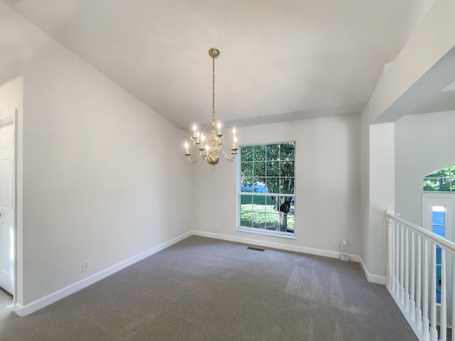 carpeted spare room featuring baseboards, a notable chandelier, visible vents, and plenty of natural light