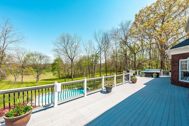 wooden deck with a hot tub and a swimming pool