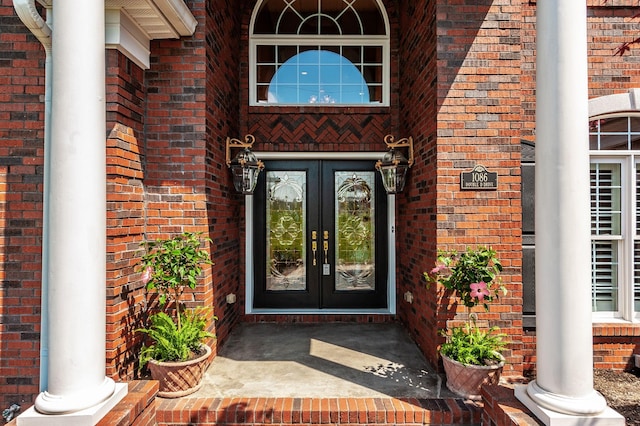 doorway to property with french doors and brick siding