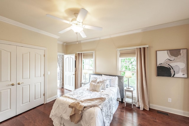 bedroom featuring baseboards, crown molding, dark wood-style flooring, and visible vents