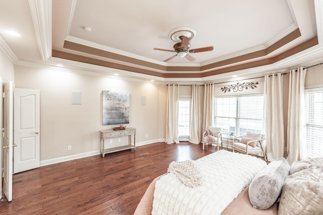 bedroom featuring multiple windows, wood-type flooring, ornamental molding, and a tray ceiling