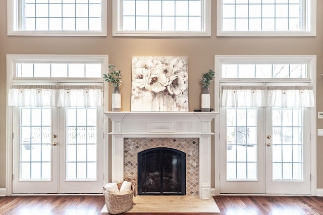 living room featuring french doors, wood finished floors, and a fireplace