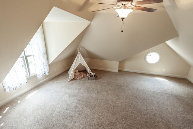 bonus room with baseboards, lofted ceiling, a ceiling fan, and carpet