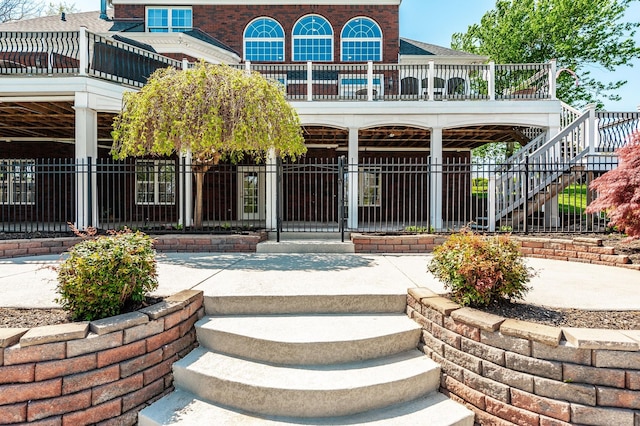 exterior space with fence and brick siding