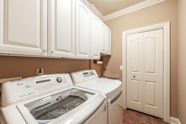 washroom featuring separate washer and dryer, a sink, ornamental molding, and cabinet space