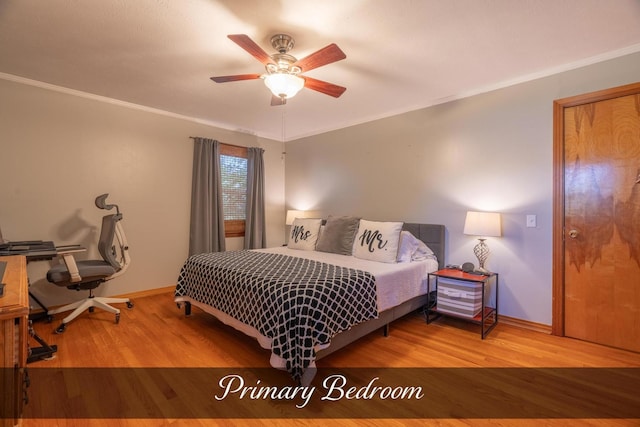 bedroom with wood finished floors, baseboards, and ornamental molding