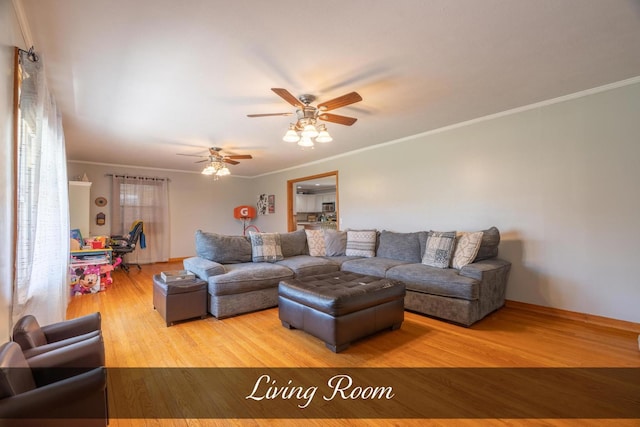 living area with a ceiling fan, crown molding, and wood finished floors