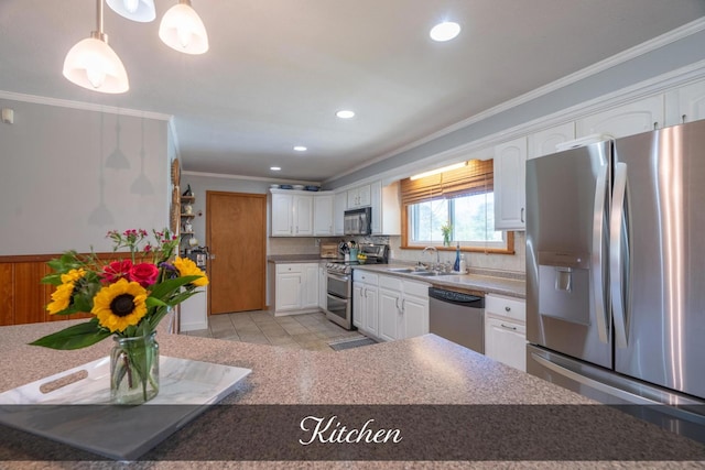 kitchen featuring decorative backsplash, light tile patterned floors, stainless steel appliances, white cabinets, and ornamental molding