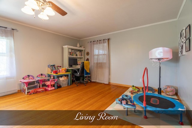 recreation room with crown molding, baseboards, a healthy amount of sunlight, and wood finished floors