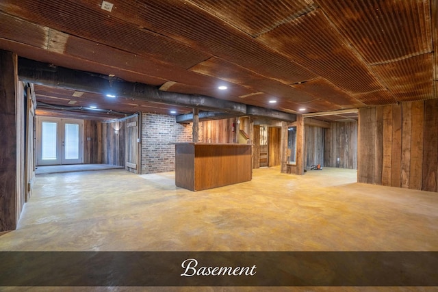 below grade area featuring a bar and wood walls