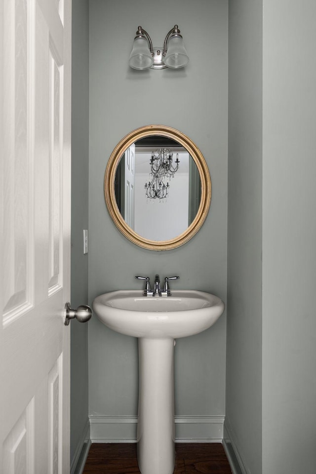 bathroom featuring wood finished floors and baseboards