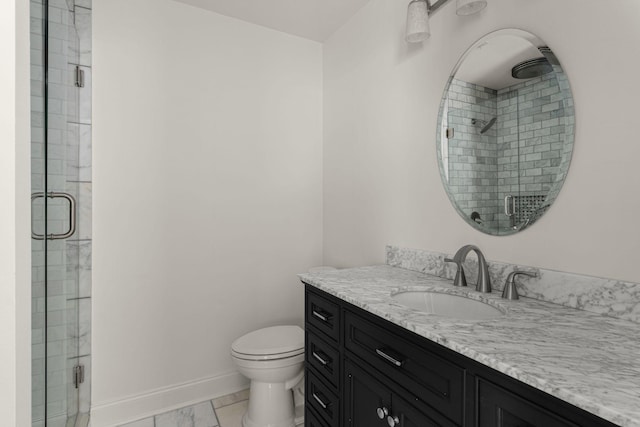 bathroom featuring toilet, marble finish floor, vanity, and a stall shower