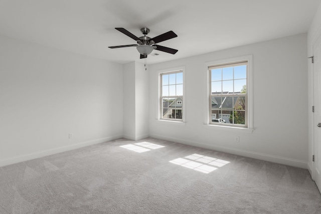 spare room featuring carpet flooring, baseboards, and a ceiling fan