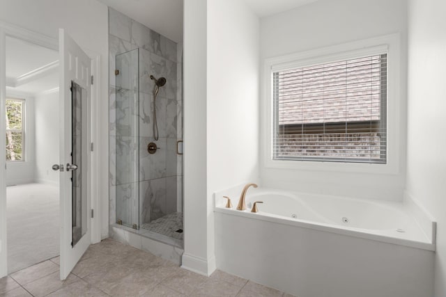 full bath featuring tile patterned floors, a marble finish shower, and a tub with jets