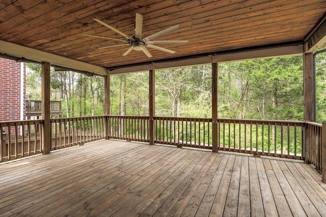 wooden deck with a ceiling fan