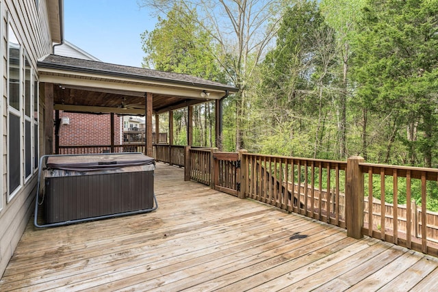 deck with ceiling fan, a hot tub, and central AC unit