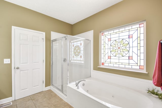 bathroom featuring tile patterned floors, a stall shower, a jetted tub, baseboards, and visible vents