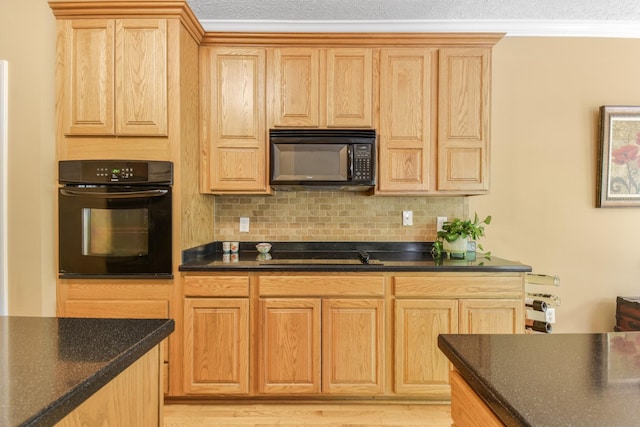kitchen featuring light brown cabinetry, decorative backsplash, and black appliances