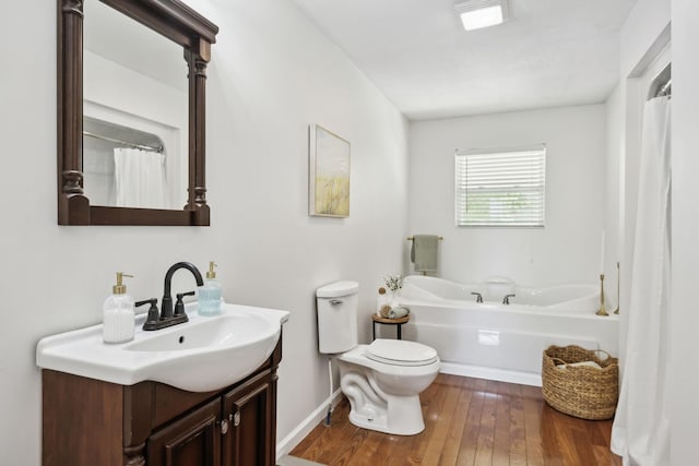 7565 N County Line Rd, Fairview, TN 37062 - bathroom with a bath, wood finished floors, vanity, baseboards, and toilet